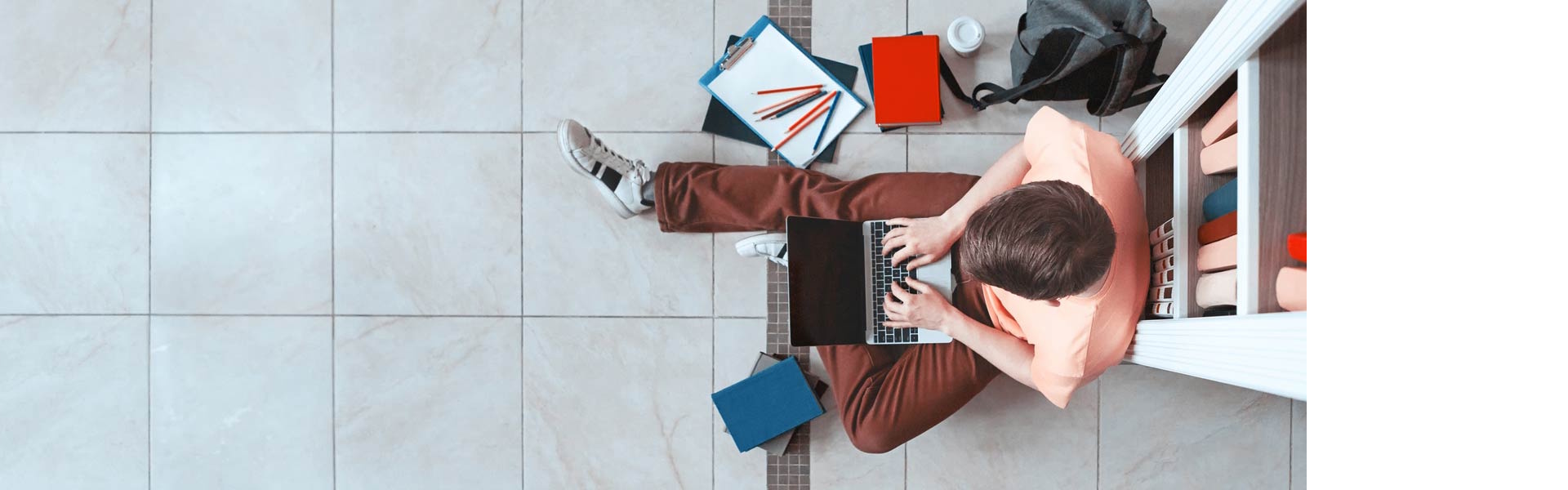 Student studying in library on laptop