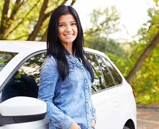Woman leaning against her SUV.